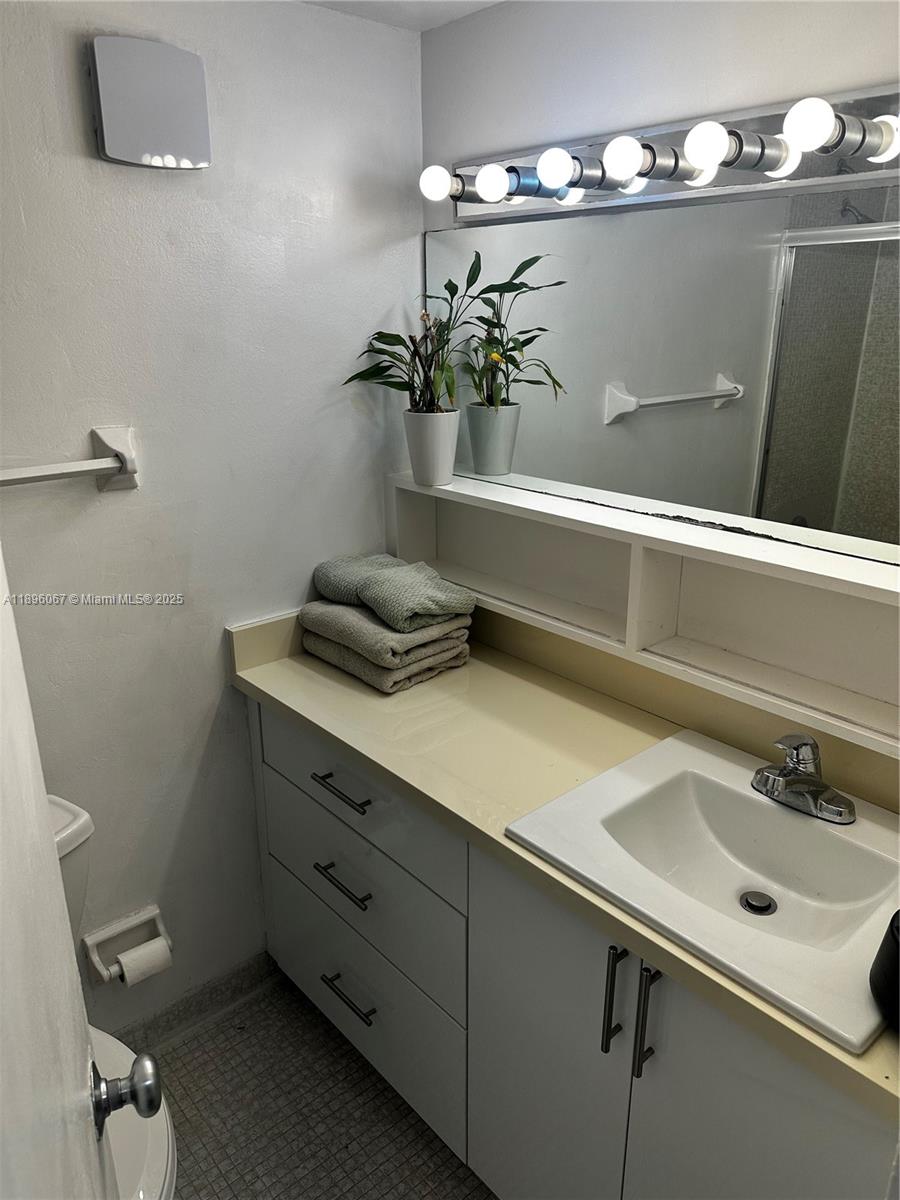 1200 West Avenue, Unit 914 Miami Beach, FL 33139 - Photo 23 of 38 a bathroom with a sink and a mirror