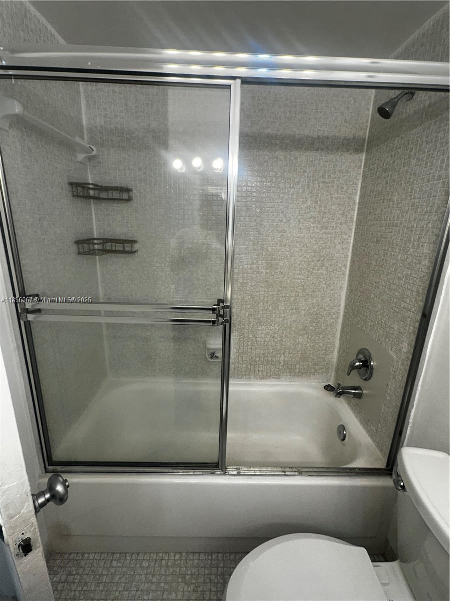 1200 West Avenue, Unit 914 Miami Beach, FL 33139 - Photo 24 of 38 a bathroom with a granite countertop sink toilet and shower