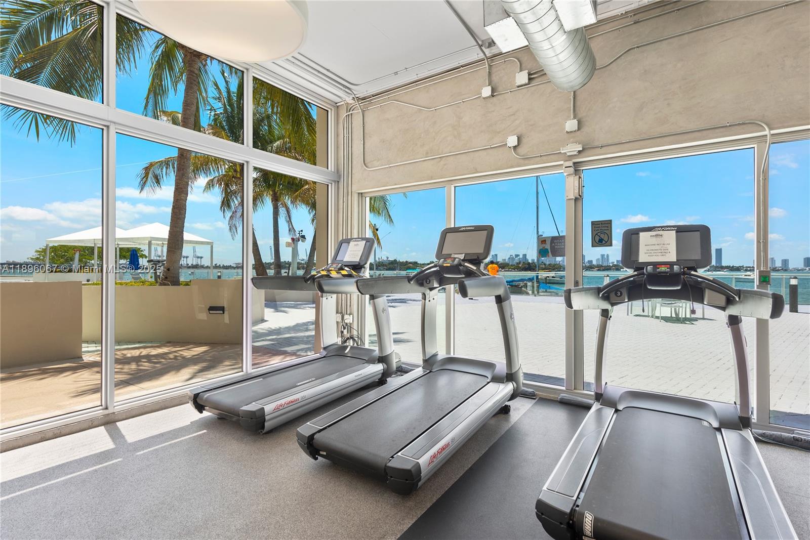 1200 West Avenue, Unit 914 Miami Beach, FL 33139 - Photo 34 of 38 a room with gym equipment and large mirror