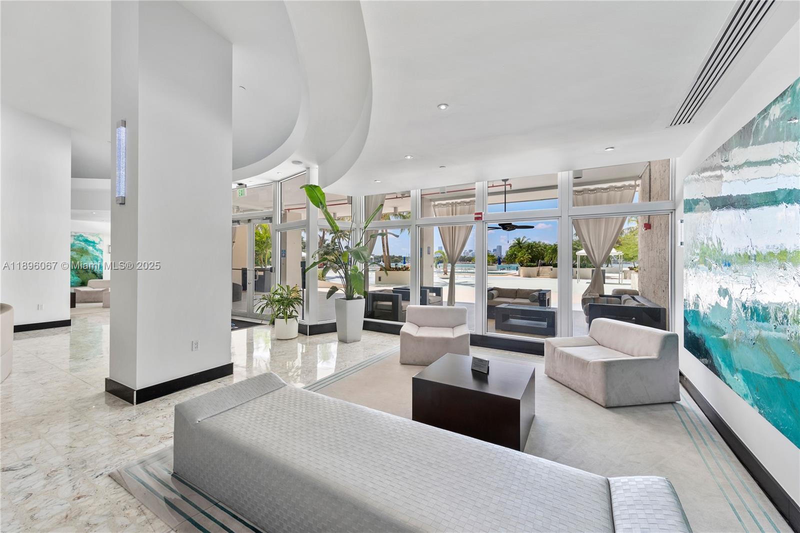 1200 West Avenue, Unit 914 Miami Beach, FL 33139 - Photo 6 of 38 a living room with furniture large windows and kitchen view