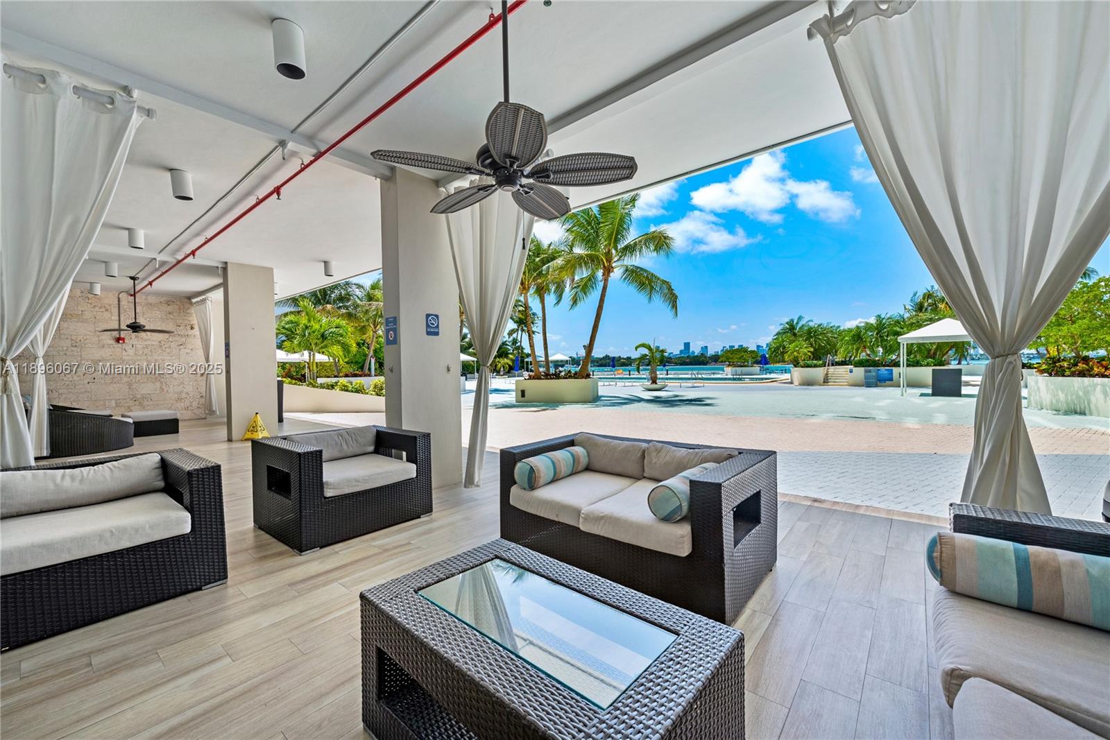 1200 West Avenue, Unit 914 Miami Beach, FL 33139 - Photo 8 of 38 a living room with patio furniture and a floor to ceiling window