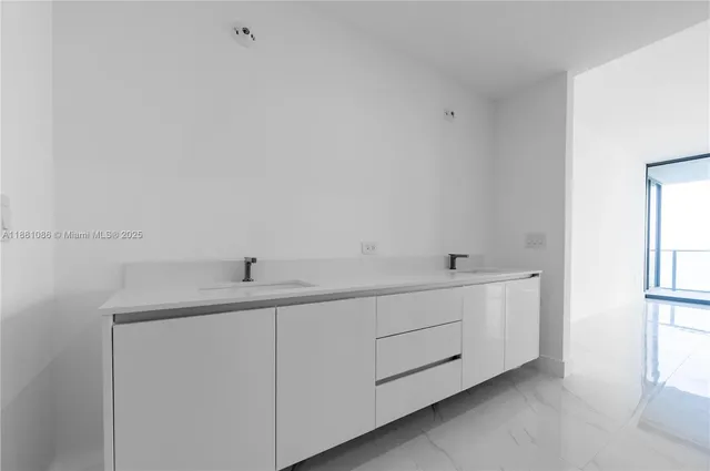 a white toilet sitting next to a white cabinet