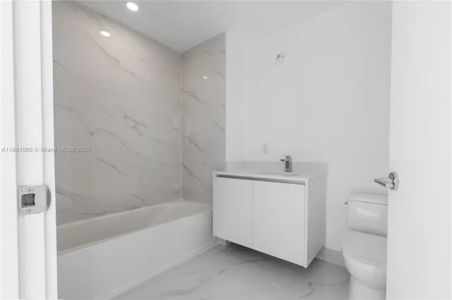 a view of kitchen with white cabinets