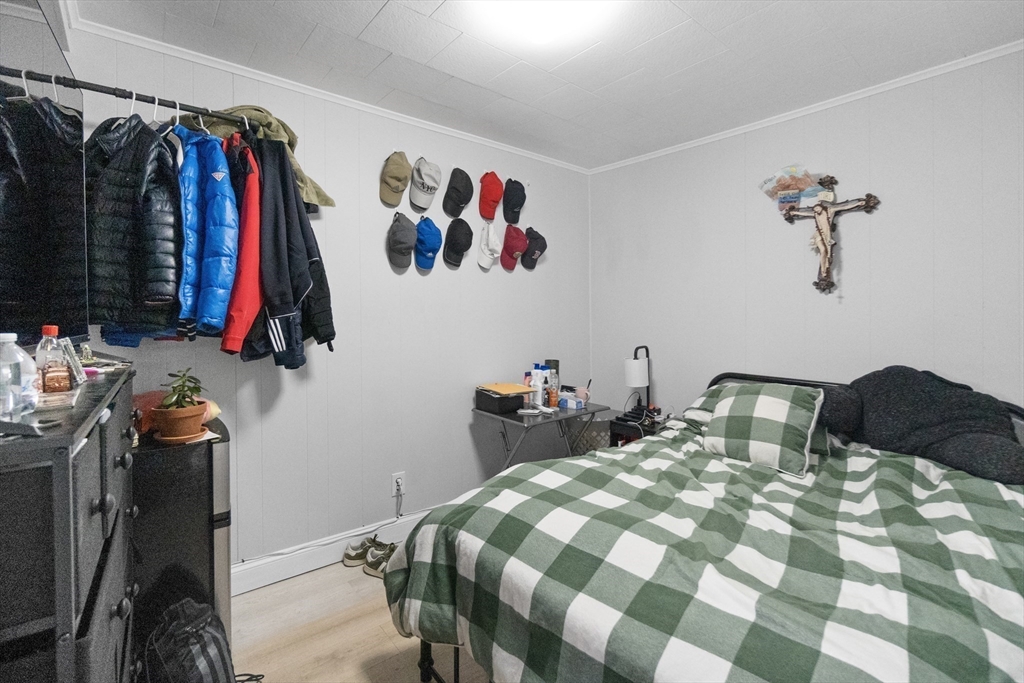 225 London Street Boston, MA 02128 - Photo 5 of 10 a bedroom with a bed and a closet