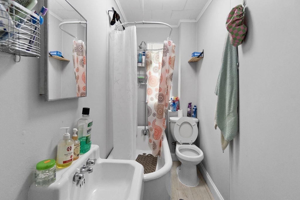 225 London Street Boston, MA 02128 - Photo 6 of 10 a bathroom with a toilet sink and shower curtain