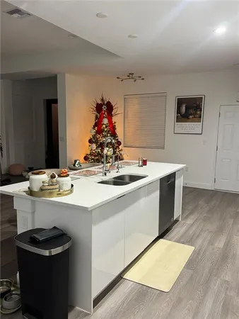 a room with a sink a table and chairs