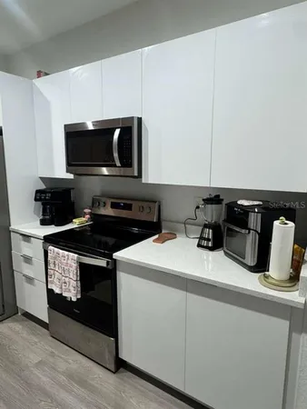 a kitchen with a sink stove and microwave
