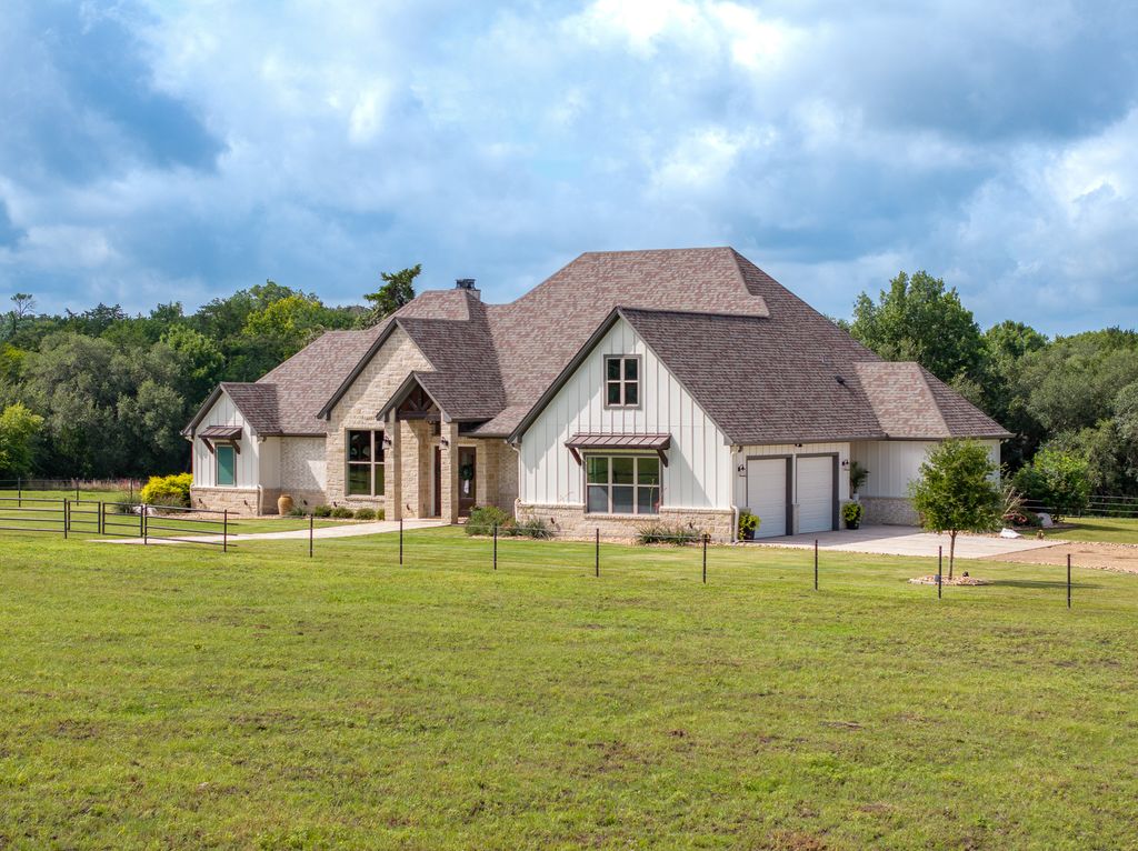 7650 Rolling Creek Road Burton, TX 77835 - Photo 2 of 22 a front view of a house with a garden