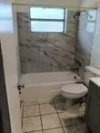 a bathroom with a toilet and a shower