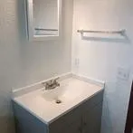 a bathroom with a sink and a white cabinet