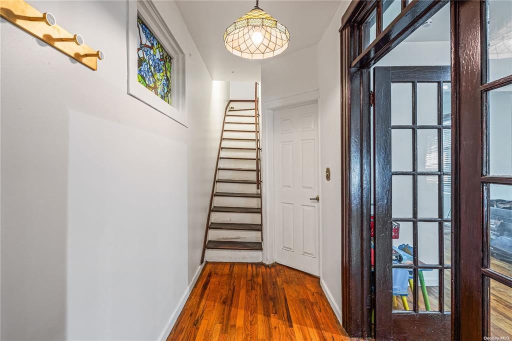 150-12 107th Avenue Queens, NY 11433 - Photo 2 of 16 a view of a hallway with wooden floor and entryway