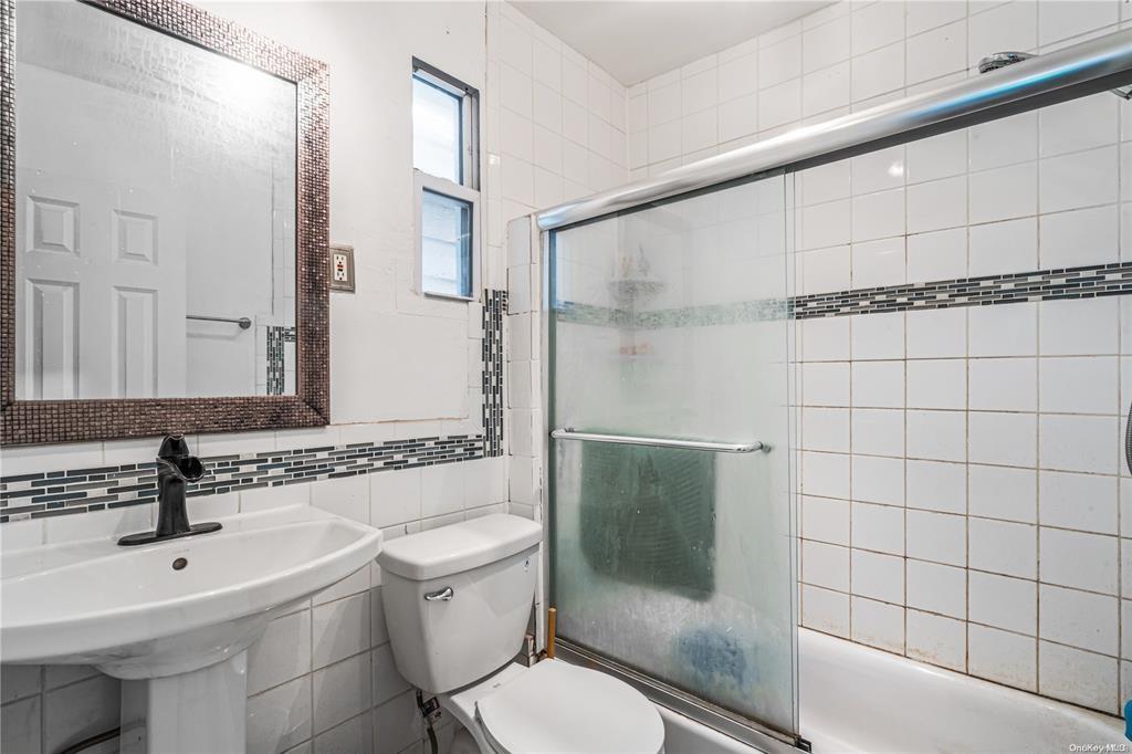 150-12 107th Avenue Queens, NY 11433 - Photo 10 of 16 a bathroom with a sink toilet and shower