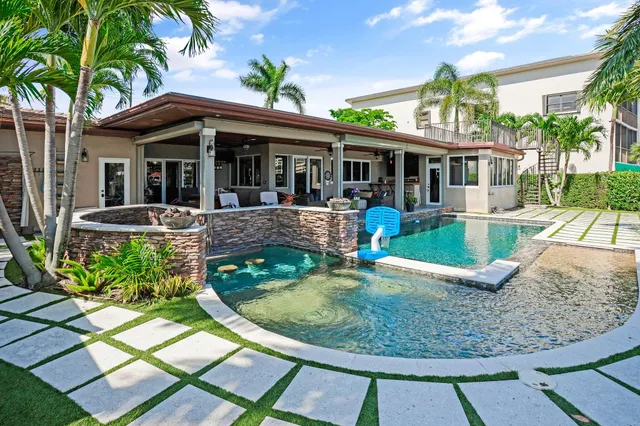 an outdoor space with swimming pool and furniture
