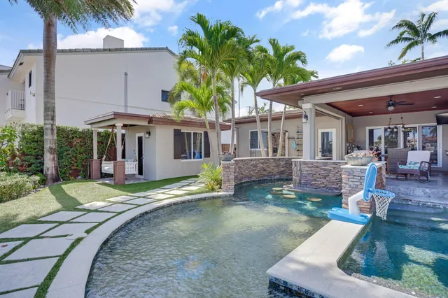 a living room with furniture a table and a potted plant