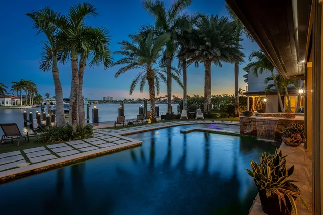 a view of a patio with dining table and chairs with wooden floor and fence