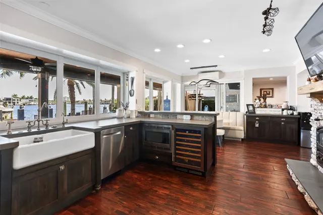 a kitchen with stainless steel appliances kitchen island granite countertop a refrigerator and a stove top oven