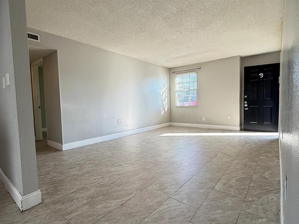2789 L B McLeod Road, Unit 2789B Orlando, FL 32805 - Photo 2 of 8 an empty room with windows and closet