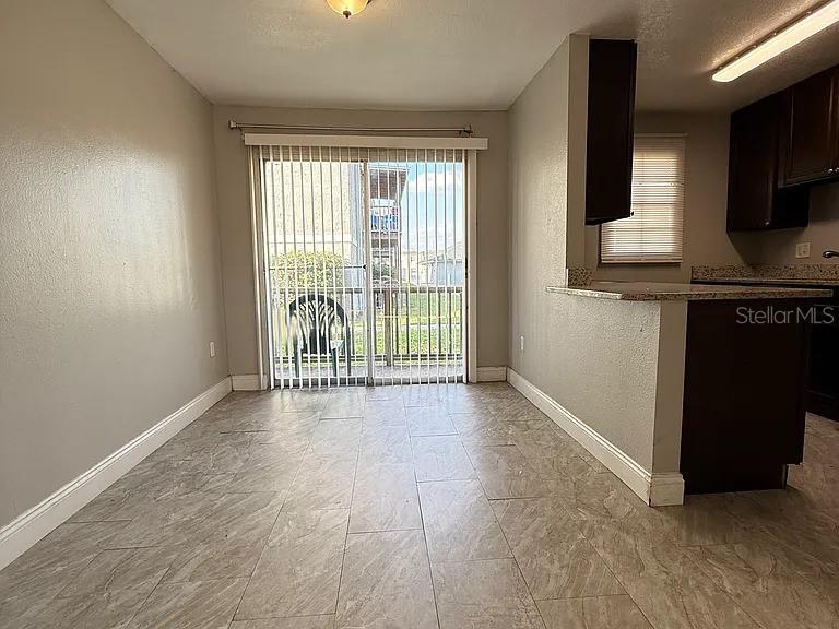 2789 L B McLeod Road, Unit 2789B Orlando, FL 32805 - Photo 5 of 8 a view of an empty room with a window and wooden floor