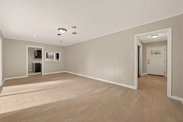 an empty room with a empty space and windows