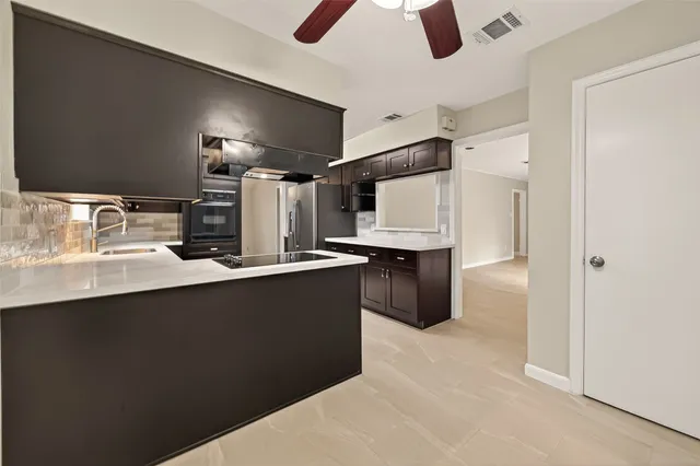 a kitchen with refrigerator and microwave