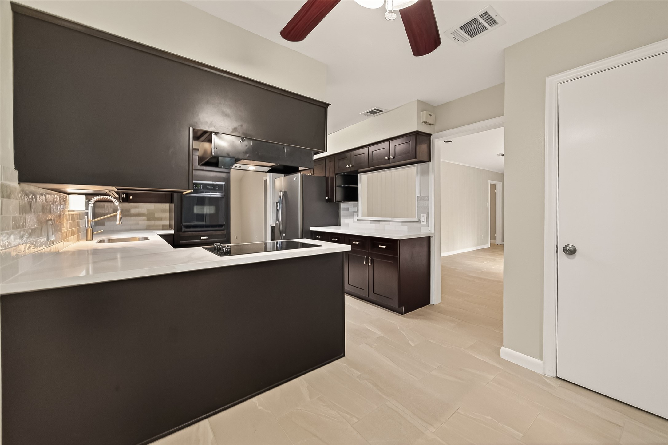 5211 Hummingbird Street Houston, TX 77035 - Photo 18 of 48 a kitchen with refrigerator and microwave