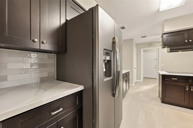 a kitchen with stainless steel appliances a refrigerator and a stove top oven
