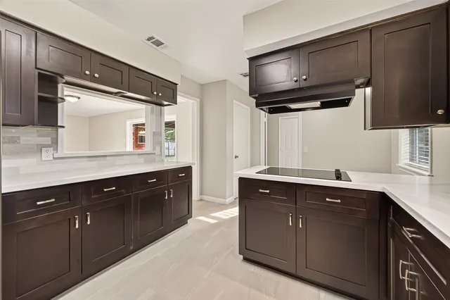 a spacious kitchen with stainless steel appliances wooden cabinets and a sink
