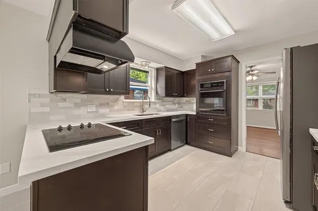 a kitchen with a sink a stove and cabinets