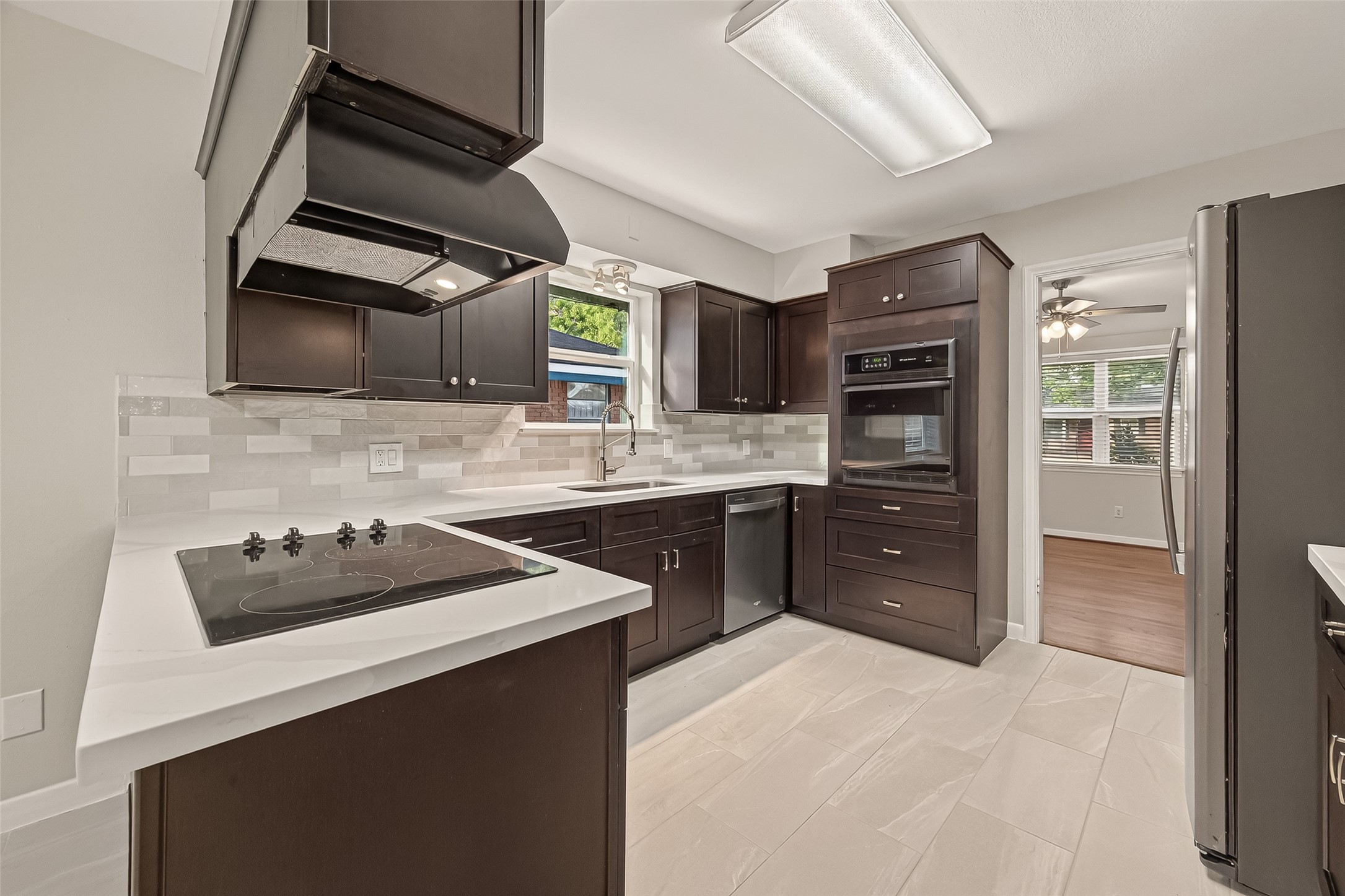 5211 Hummingbird Street Houston, TX 77035 - Photo 24 of 48 a kitchen with a sink a stove and cabinets
