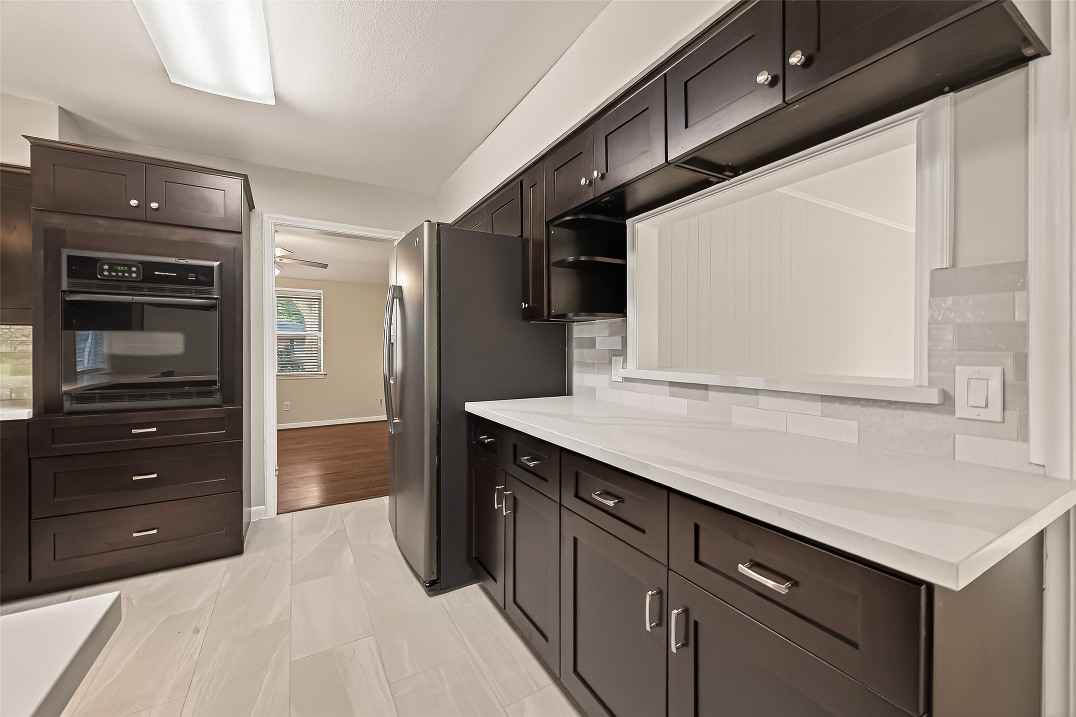 5211 Hummingbird Street Houston, TX 77035 - Photo 25 of 48 a kitchen with a wooden floor and cabinets