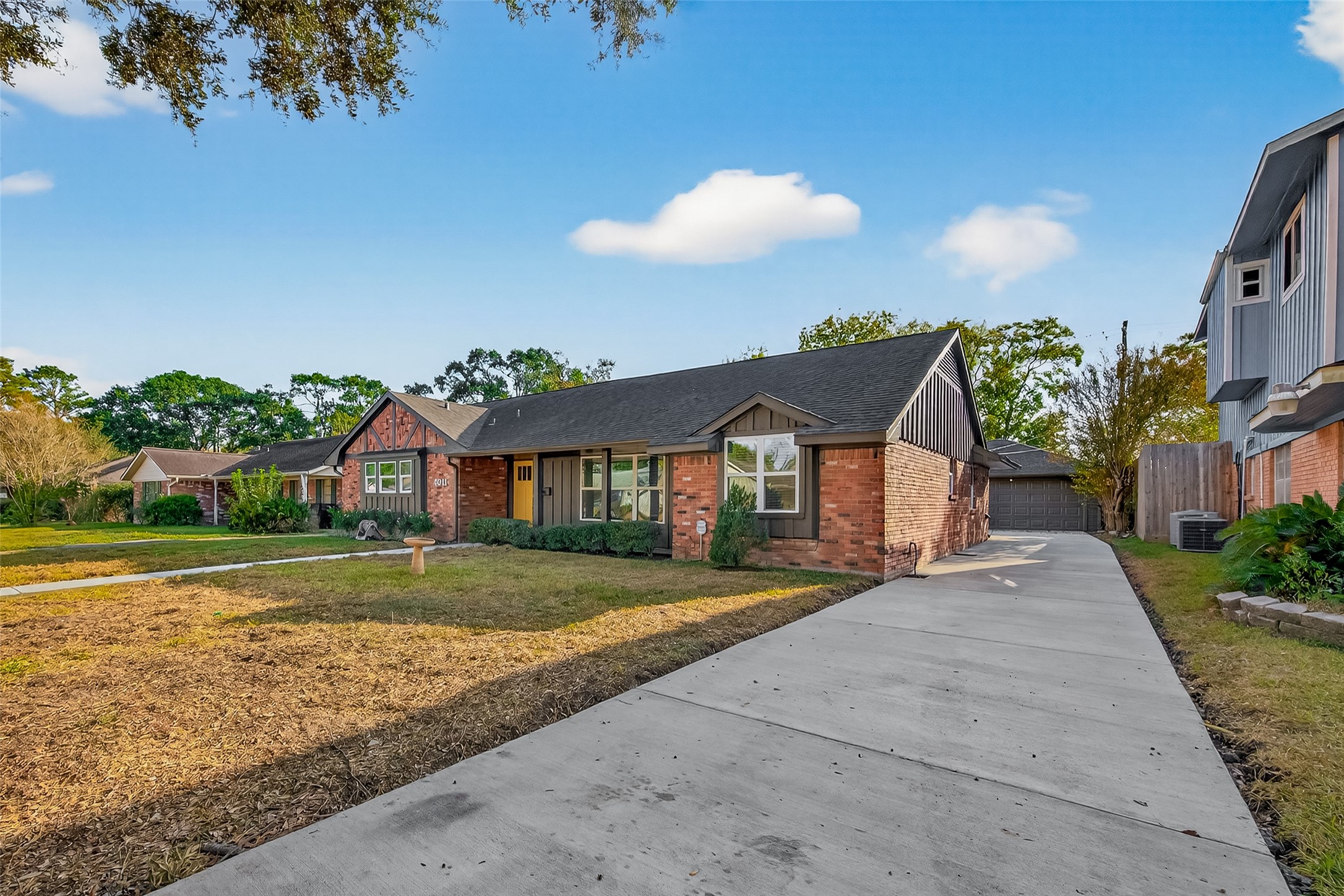 5211 Hummingbird Street Houston, TX 77035 - Photo 3 of 48 a front view of a house with a yard and garage