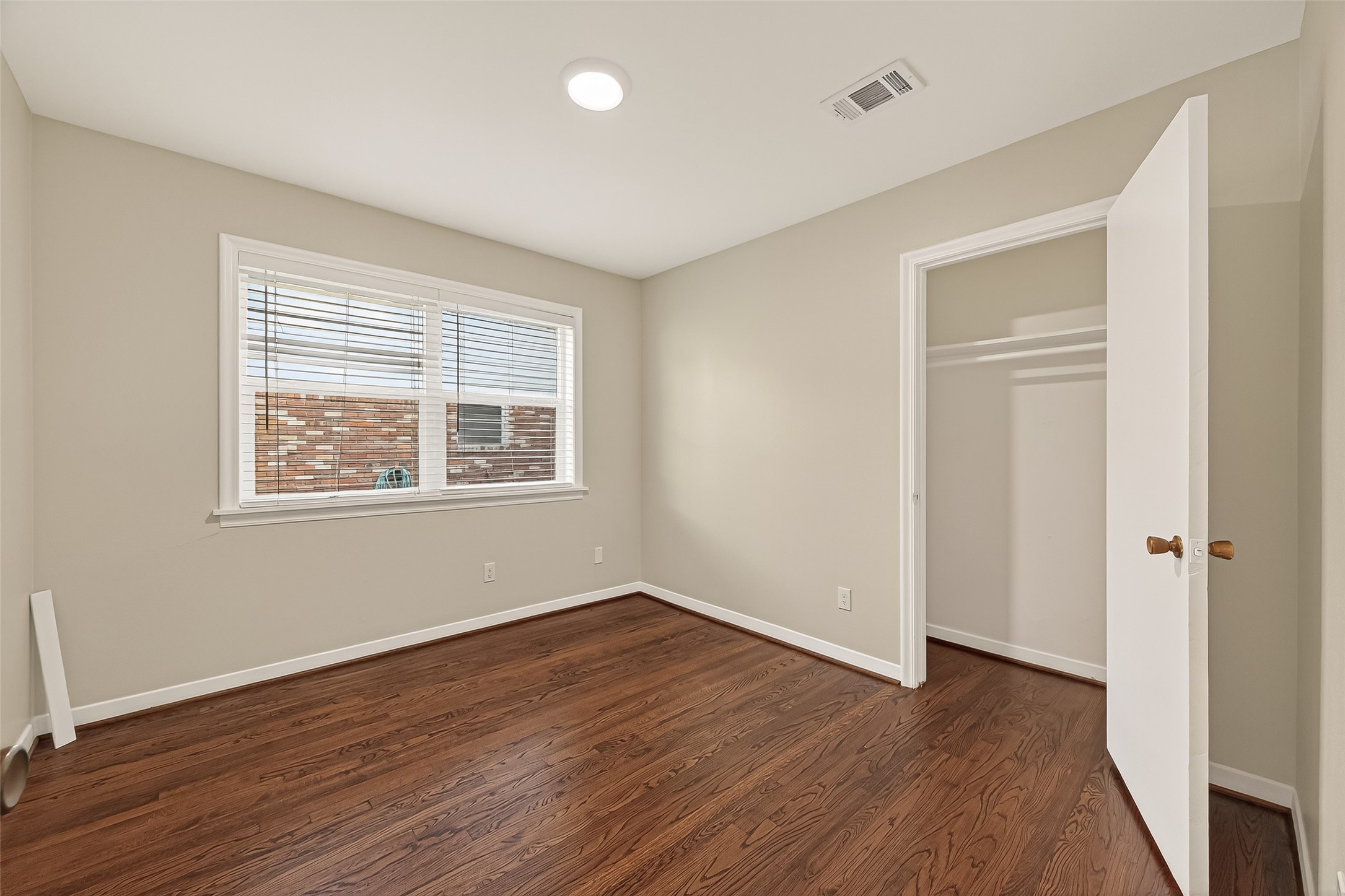 5211 Hummingbird Street Houston, TX 77035 - Photo 32 of 48 a view of an empty room with wooden floor and a window