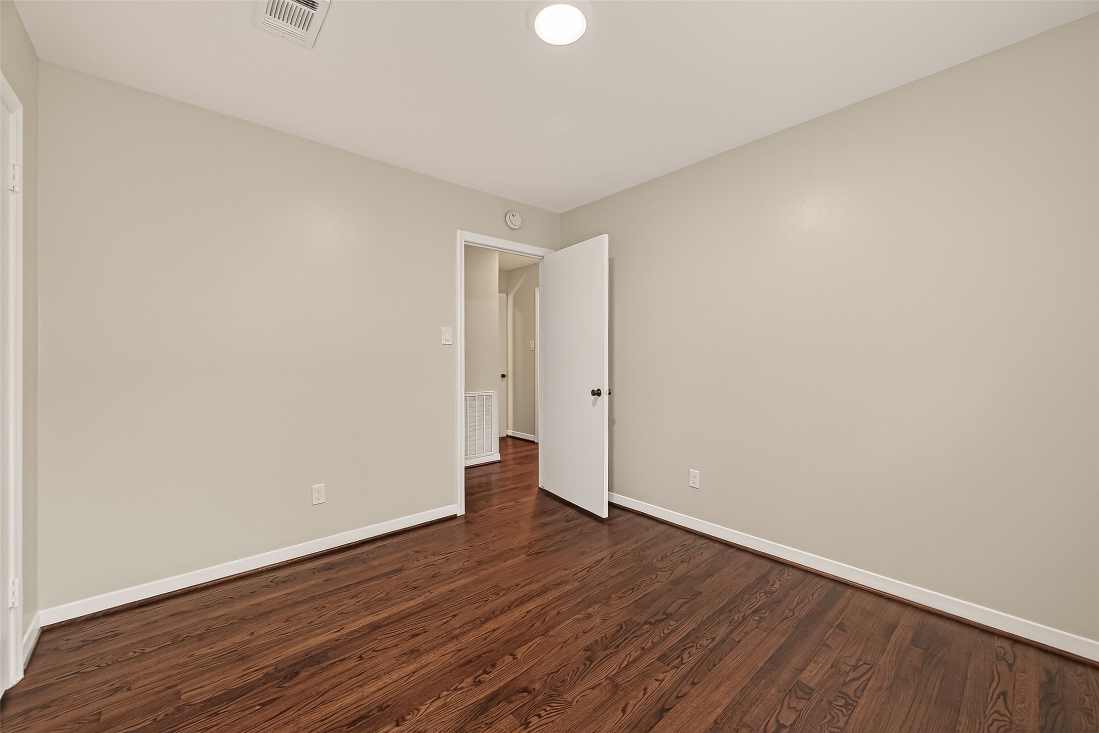 5211 Hummingbird Street Houston, TX 77035 - Photo 33 of 48 a view of an empty room with wooden floor