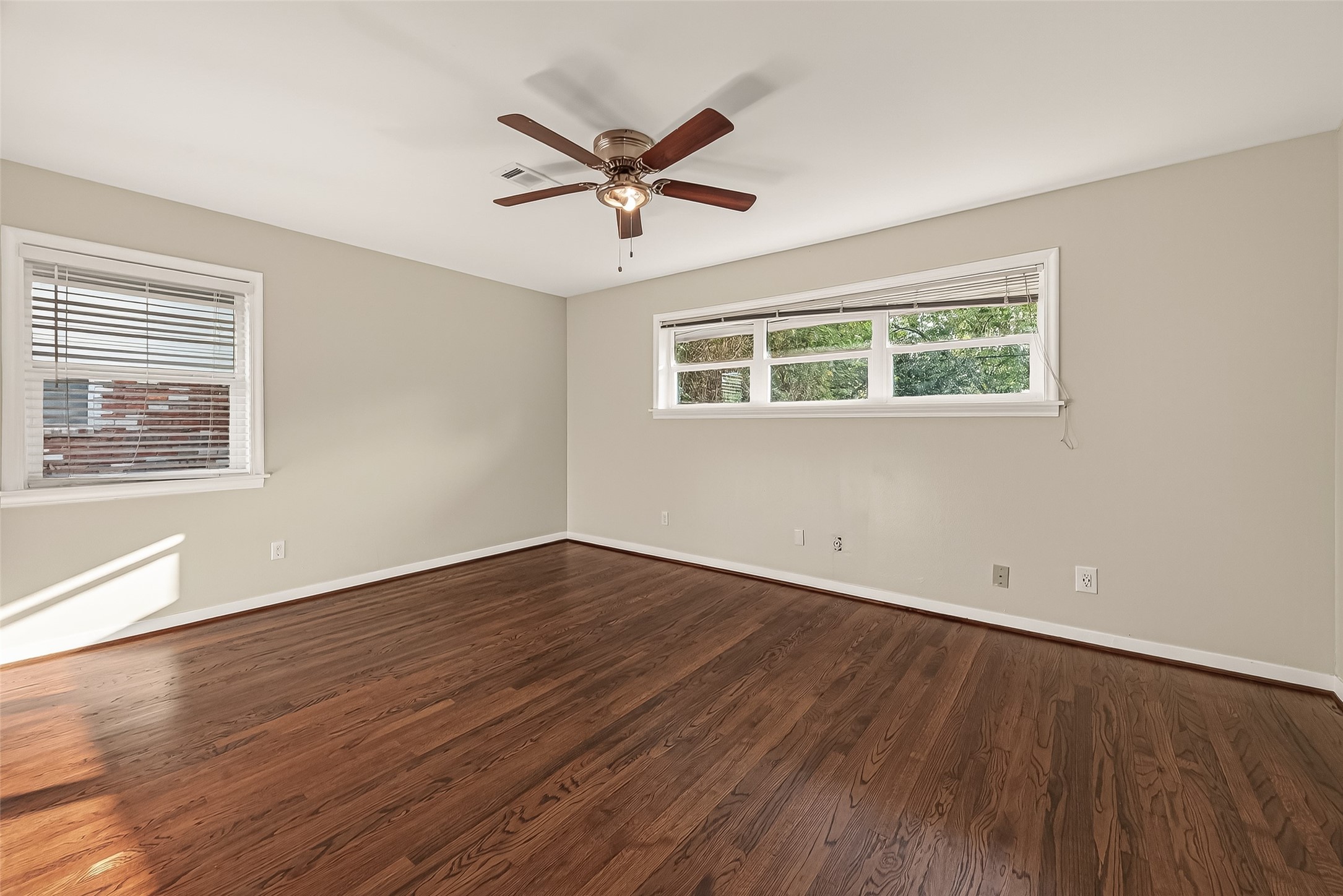 5211 Hummingbird Street Houston, TX 77035 - Photo 35 of 48 a view of a big room with wooden floor and windows