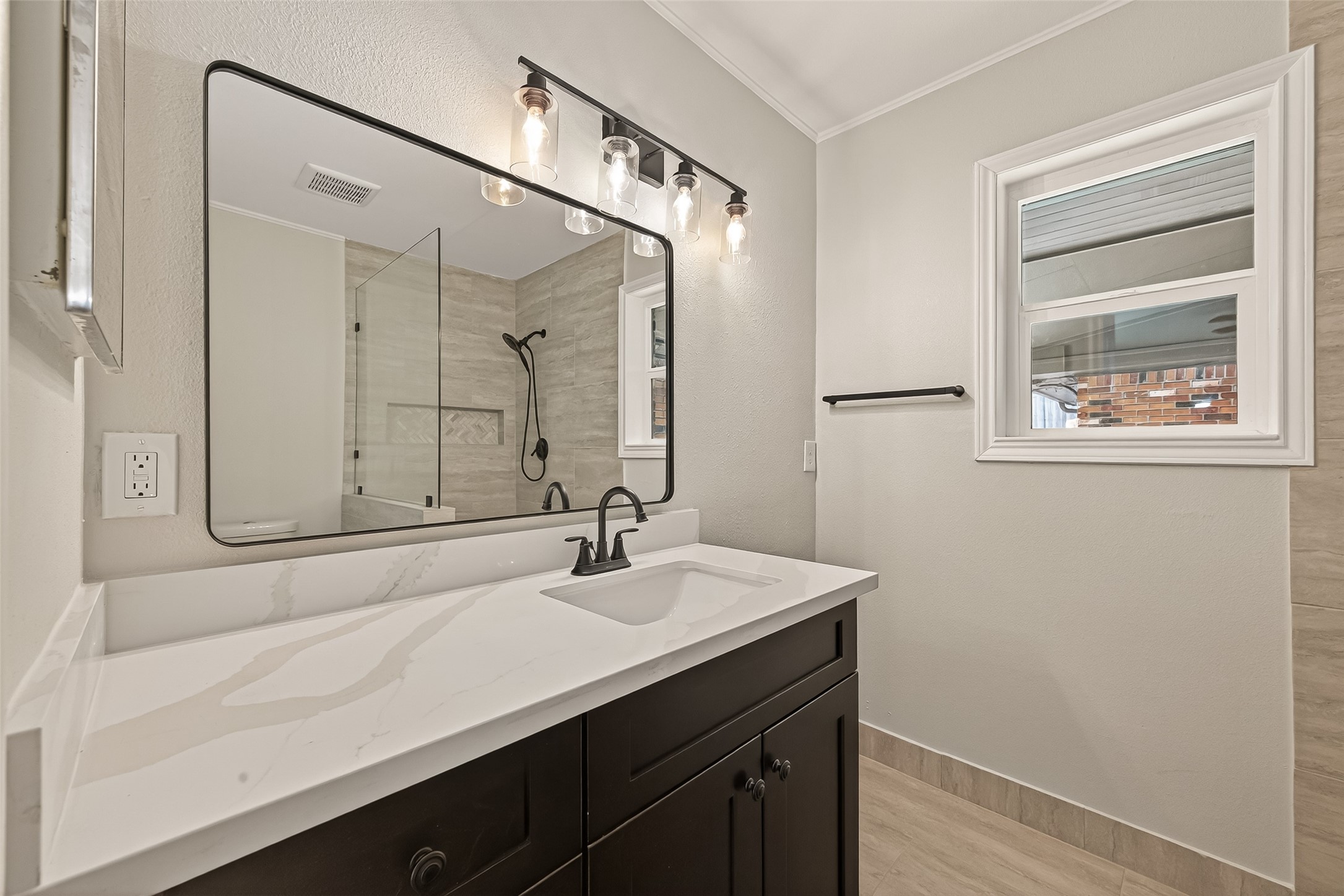 5211 Hummingbird Street Houston, TX 77035 - Photo 39 of 48 a bathroom with a sink a mirror and a shower