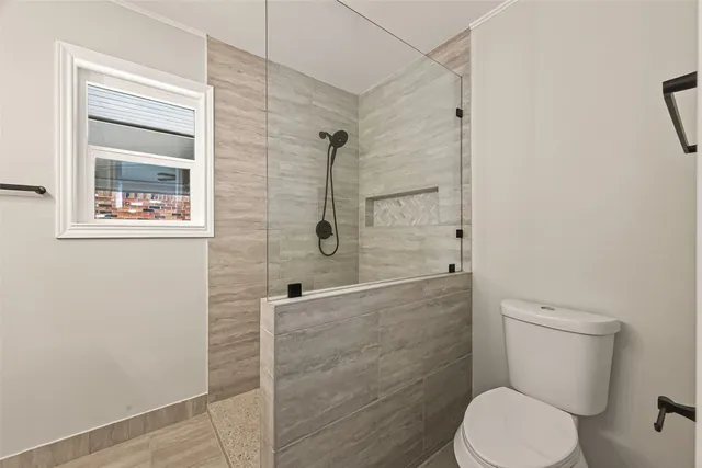 a white toilet sitting next to a bathroom sink