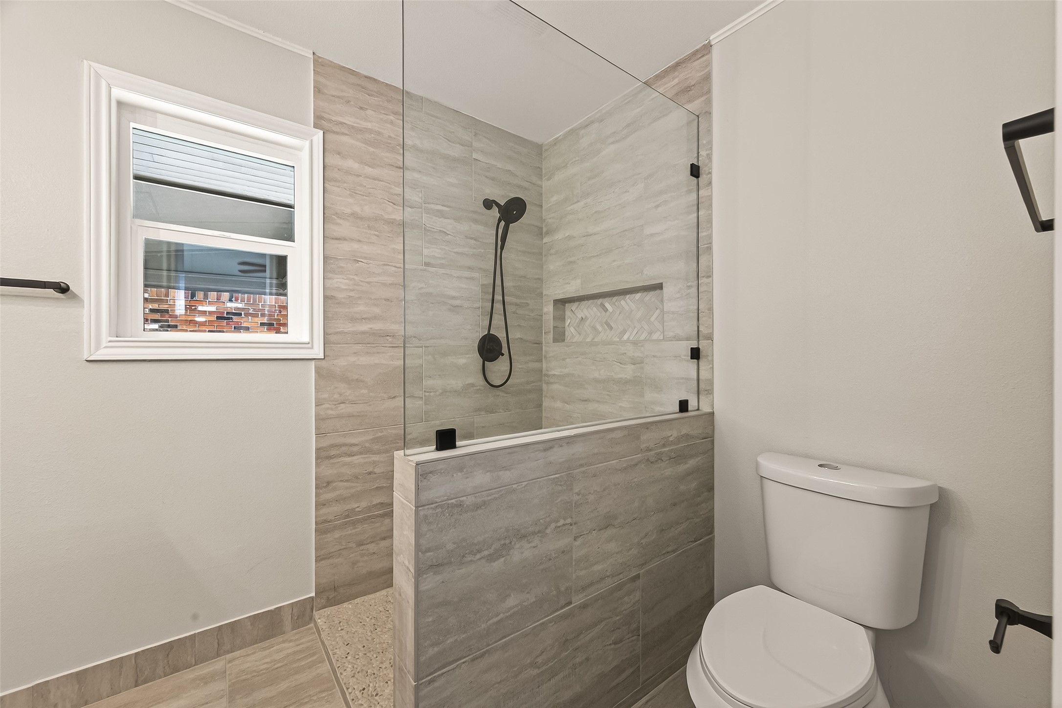 5211 Hummingbird Street Houston, TX 77035 - Photo 40 of 48 a white toilet sitting next to a bathroom sink