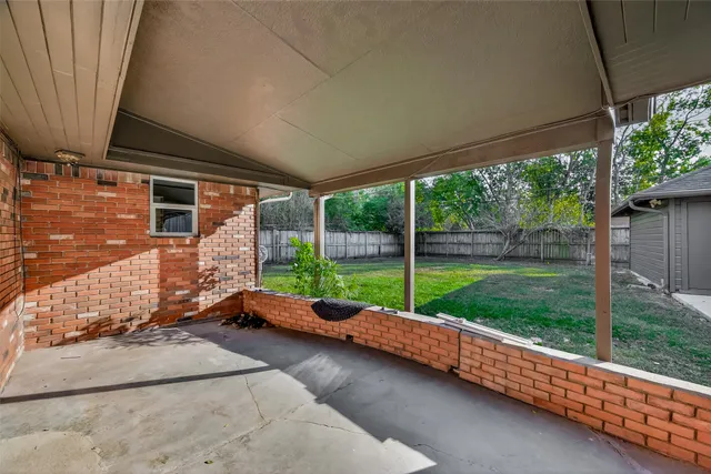 a view of a house with backyard and porch