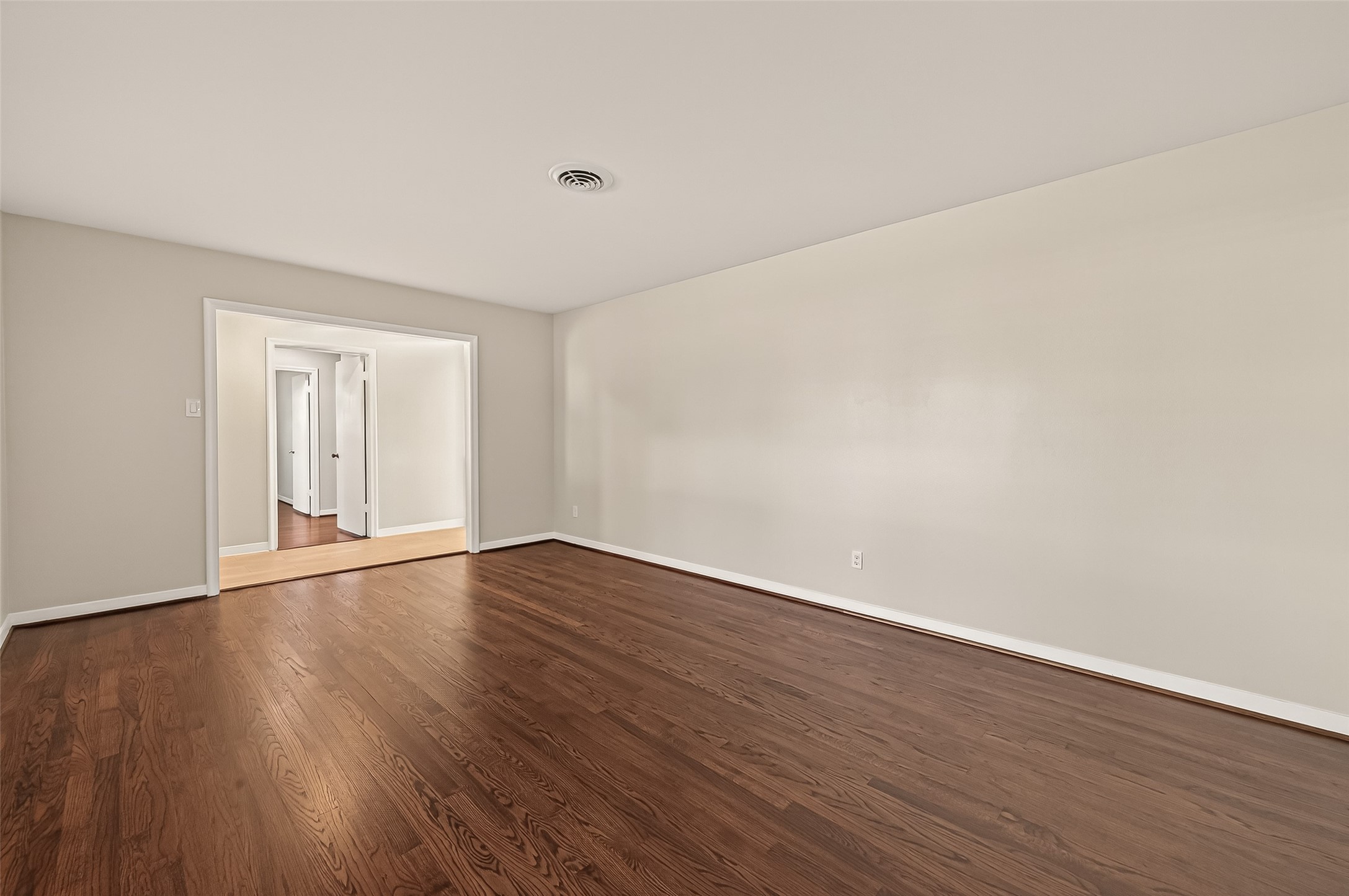 5211 Hummingbird Street Houston, TX 77035 - Photo 9 of 48 a view of an empty room with wooden floor and windows