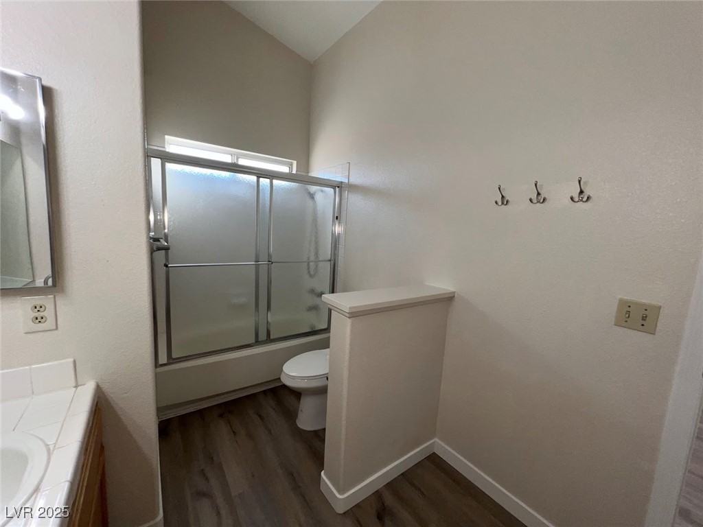 635 Delorean Drive North Las Vegas, NV 89081 - Photo 14 of 22 Bathroom with combined bath / shower with glass door, vanity, and dark wood finished floors