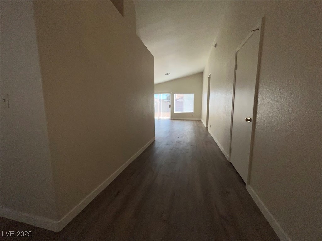 635 Delorean Drive North Las Vegas, NV 89081 - Photo 7 of 22 Corridor with lofted ceiling and dark wood-style floors
