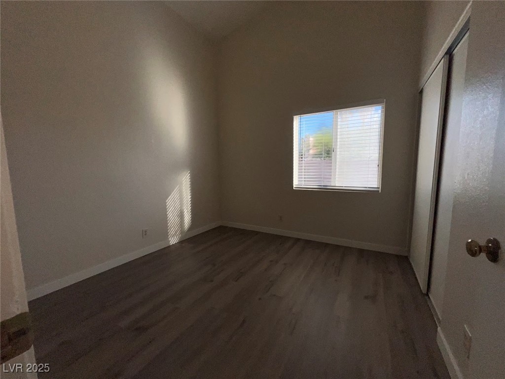 635 Delorean Drive North Las Vegas, NV 89081 - Photo 9 of 22 Unfurnished bedroom with dark wood-style flooring and a closet