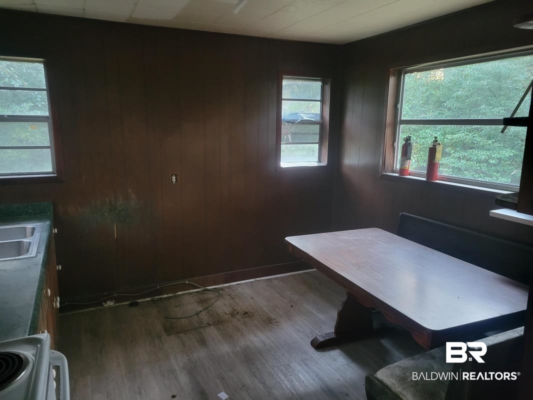 2059 Magnolia Lane Mobile, AL 36605 - Photo 13 of 17 Office space featuring plenty of natural light, wooden walls, and wood finished floors