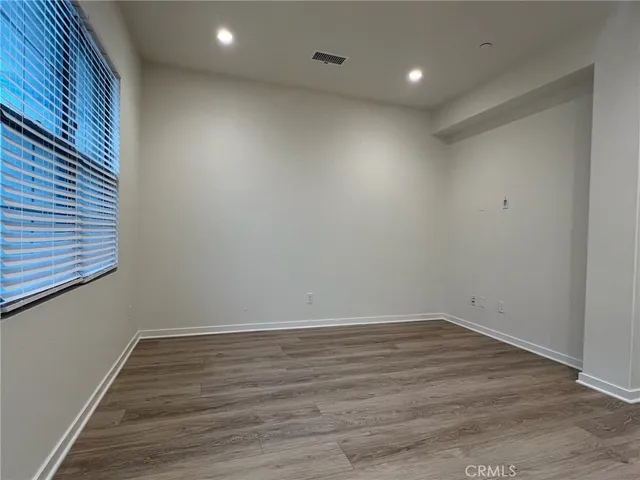 a view of room with wooden floor and fan