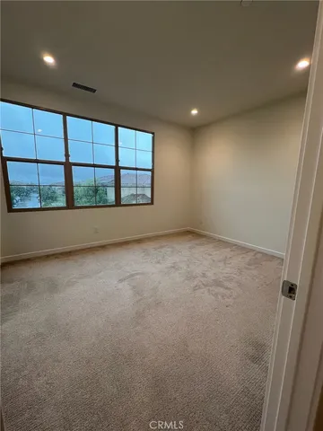 an empty room with a empty space and window