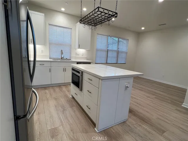 a kitchen with a sink a refrigerator and window