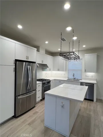 a kitchen with a sink stainless steel appliances and cabinets