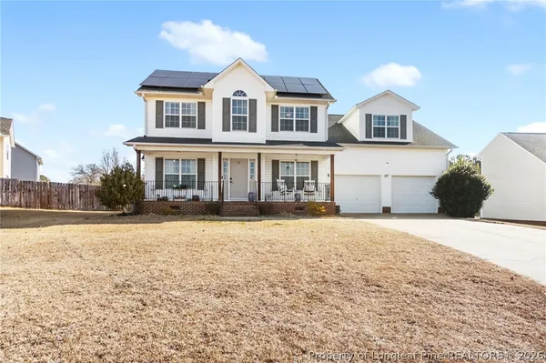 a front view of a house with a yard and garage
