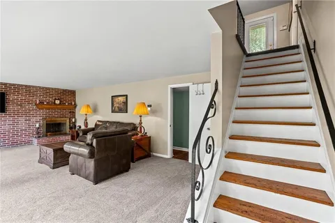 a view of a livingroom with furniture and staircase