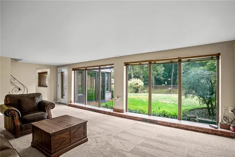 a living room with furniture and large windows